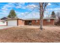 Brick ranch home with a spacious front yard at 638 S Troy St, Aurora, CO 80012