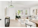 Bright living room featuring neutral decor, large windows, and hardwood flooring at 5282 E 116Th Ave, Thornton, CO 80233