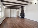 Living room with hardwood floors, fireplace, and exposed beam ceiling at 4348 S Jason St, Englewood, CO 80110