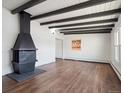 Living room showcasing hardwood floors and a vintage fireplace at 4348 S Jason St, Englewood, CO 80110