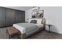 Comfortable bedroom with neutral tones, a large closet and bench at 1601 Park Ave # 112, Denver, CO 80218