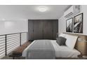Comfortable bedroom with neutral tones, a large closet and bench at 1601 Park Ave # 112, Denver, CO 80218