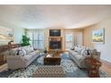 Inviting living room with fireplace, plush seating, and abundant natural light at 701 Harlan St # E27, Lakewood, CO 80214