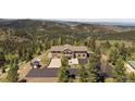 Beautiful front exterior featuring large windows, attached garage, and driveway at 13007 Kuehster Rd, Littleton, CO 80127
