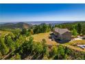 Elegant two-story home surrounded by mature trees and stunning mountain views at 13007 Kuehster Rd, Littleton, CO 80127