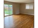 Bright living room features beautiful hardwood floors and a sliding glass door to the backyard at 7123 Winona Ct, Westminster, CO 80030