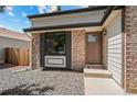 Close up on the home's entrance showcasing the front door and decorative brickwork at 7633 Gray Way, Arvada, CO 80003