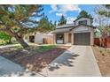 Charming two-story home with brick facade, attached garage, and well-maintained lawn at 7633 Gray Way, Arvada, CO 80003