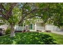 Beautifully landscaped front yard with mature trees, providing curb appeal to this inviting home at 22739 E Prentice Pl, Aurora, CO 80015