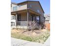 Charming home features a covered porch and neat landscaping at 21795 E 8Th Ave, Aurora, CO 80018