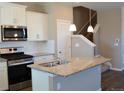 Bright kitchen featuring stainless steel appliances, granite countertops, and a stylish island at 21795 E 8Th Ave, Aurora, CO 80018