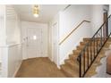 Front entry with staircase, carpet, and room divider at 6740 S Clarkson St, Centennial, CO 80122