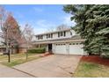 Classic two-story home boasting an attached two-car garage and lush front yard at 3966 S Magnolia Way, Denver, CO 80237