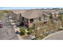 Exterior of a two-story home with a well-manicured lawn and a two-car garage and beautiful roof at 10162 Bluffmont Ln, Lone Tree, CO 80124