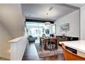 View of the dining and living area shows a sunlit room with stylish decor and hardwood floors at 852 Kalamath St, Denver, CO 80204
