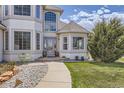 Inviting entryway with stone landscaping, a small seating area, and a well-manicured lawn at 29852 E 163Rd Pl, Brighton, CO 80603