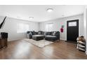 Spacious living room with hardwood floors, lots of natural light, and a comfortable gray sectional couch at 850 Grove St, Denver, CO 80204