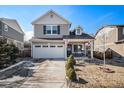 Charming two-story home with a well-maintained lawn and an attached two-car garage at 1959 Morningview Ln, Castle Rock, CO 80109