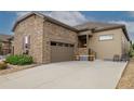Beautiful stone and siding home with a wide driveway leading to an attached two-car garage at 3418 New Haven Cir, Castle Rock, CO 80109