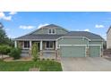 Charming single-Gathering home featuring a well-manicured lawn and a welcoming front porch at 42013 Big Horn Cir, Elizabeth, CO 80107