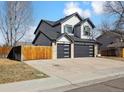 Side view of a well-kept home with an attached three-car garage, showcasing ample parking at 8983 W Capri Ave, Littleton, CO 80123