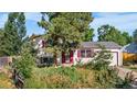 Charming home with bright shutters and an attached garage, surrounded by mature trees at 10463 Kipling Ct, Broomfield, CO 80021