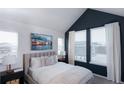 Inviting bedroom with a vaulted ceiling, white bedding and a serene atmosphere at 11958 W 57Th Pl, Arvada, CO 80002
