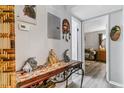 Hallway with table, decor, and doorway views into other rooms at 3320 S Ammons St # 104, Lakewood, CO 80227
