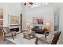 Bright living room featuring vaulted ceilings, a fireplace, and stylish decor at 6735 Avrum Dr, Denver, CO 80221