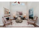 Bright living room featuring vaulted ceilings, a fireplace, and stylish decor at 6735 Avrum Dr, Denver, CO 80221