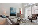 Cozy living room with a plush rug, comfortable seating, and sliding glass doors at 6735 Avrum Dr, Denver, CO 80221