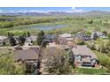 Stunning aerial view of a beautiful community with a pond and golf course in the background at 3002 S Oak Way, Lakewood, CO 80227