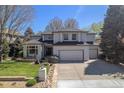 Beautiful two-story home boasting a manicured lawn, rock garden, and a spacious two-car garage at 3002 S Oak Way, Lakewood, CO 80227