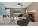 Inviting living room featuring a fireplace, large window, and comfortable seating at 411 S Cody Ct, Lakewood, CO 80226