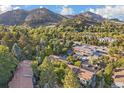 Aerial view of residential buildings nestled among lush greenery and mountains at 350 Arapahoe Ave # 17, Boulder, CO 80302