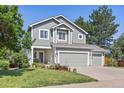 Charming two-story home with a well-maintained lawn, mature trees and a three-car garage at 18899 E Whitaker Cir, Aurora, CO 80015