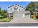 Charming two-story home with a well-maintained lawn, mature trees and a three-car garage at 18899 E Whitaker Cir, Aurora, CO 80015