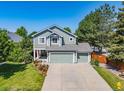 Charming two-story home with a well-maintained lawn, mature trees and a three-car garage at 18899 E Whitaker Cir, Aurora, CO 80015