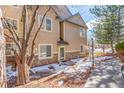 Inviting condo exterior featuring stone accents, a covered entrance, and a tidy walkway at 8374 S Holland Way # 202, Littleton, CO 80128