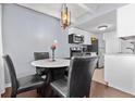 A dining area features a round marble table with seating for four under a pendant light at 200 N Pearl St # 106, Denver, CO 80203