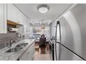 The kitchen showcases stainless appliances with a view of an adjacent dining area at 200 N Pearl St # 106, Denver, CO 80203
