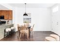 Dining area with a round table and four woven chairs at 16091 E Geddes Dr # 74, Aurora, CO 80016