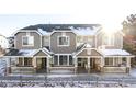 Three-unit townhome building with snow-covered front yards at 16091 E Geddes Dr # 74, Aurora, CO 80016