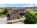 Stunning two-story home with stone accents, lush landscaping, and a sprawling lawn in a quiet neighborhood at 9928 Bluestar Dr, Parker, CO 80138