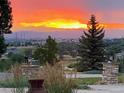 Picturesque sunset view from property showcasing vibrant colors over rolling hills and distant mountains at 9928 Bluestar Dr, Parker, CO 80138
