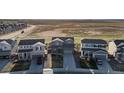 Areal view of a neighborhood with houses, lawns, and open space in the background at 6211 Bauer Dr, Frederick, CO 80504