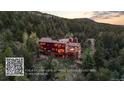 Beautiful mountain home with ample deck space and scenic views, with a QR code overlay at 30717 Conifer Mountain Dr, Conifer, CO 80433