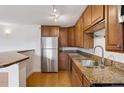 Well-appointed kitchen featuring granite countertops, stainless steel appliances, and plenty of cabinet space for storage at 1 N Pearl St # 102, Denver, CO 80203