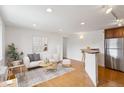 Bright living room with hardwood floors, modern decor, and an open layout to the kitchen, perfect for entertaining at 1 N Pearl St # 102, Denver, CO 80203