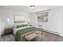 Serene bedroom with a comfortable queen-sized bed, soft carpet, and a large window for natural light at 1 N Pearl St # 102, Denver, CO 80203